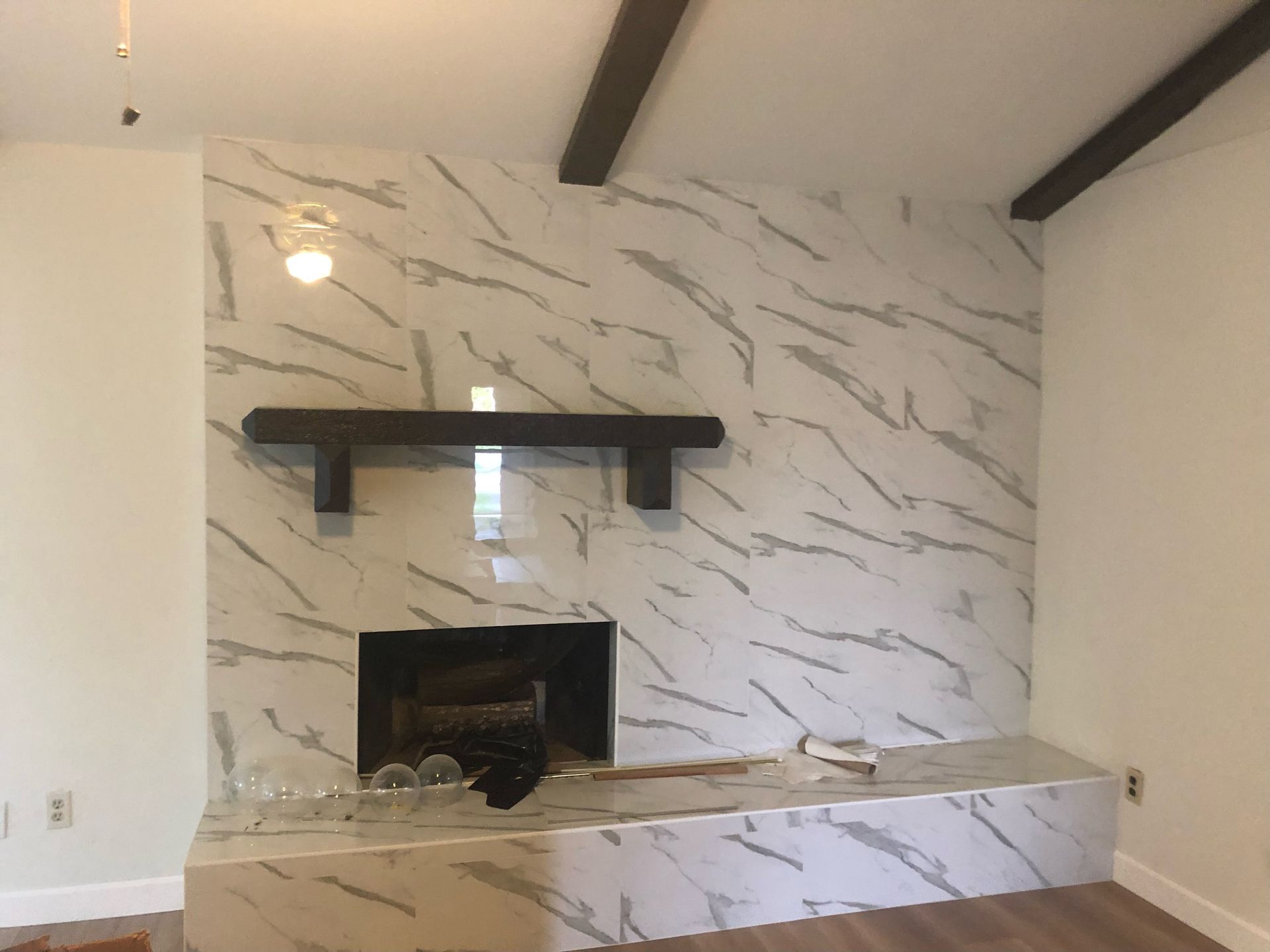 White Marble Wall with black Shelf and fire place