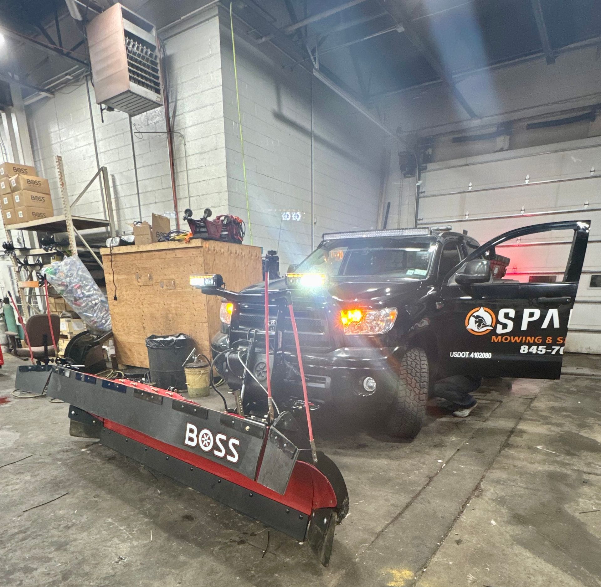 Row of green shrubs in newly mulched bed alongside a house.