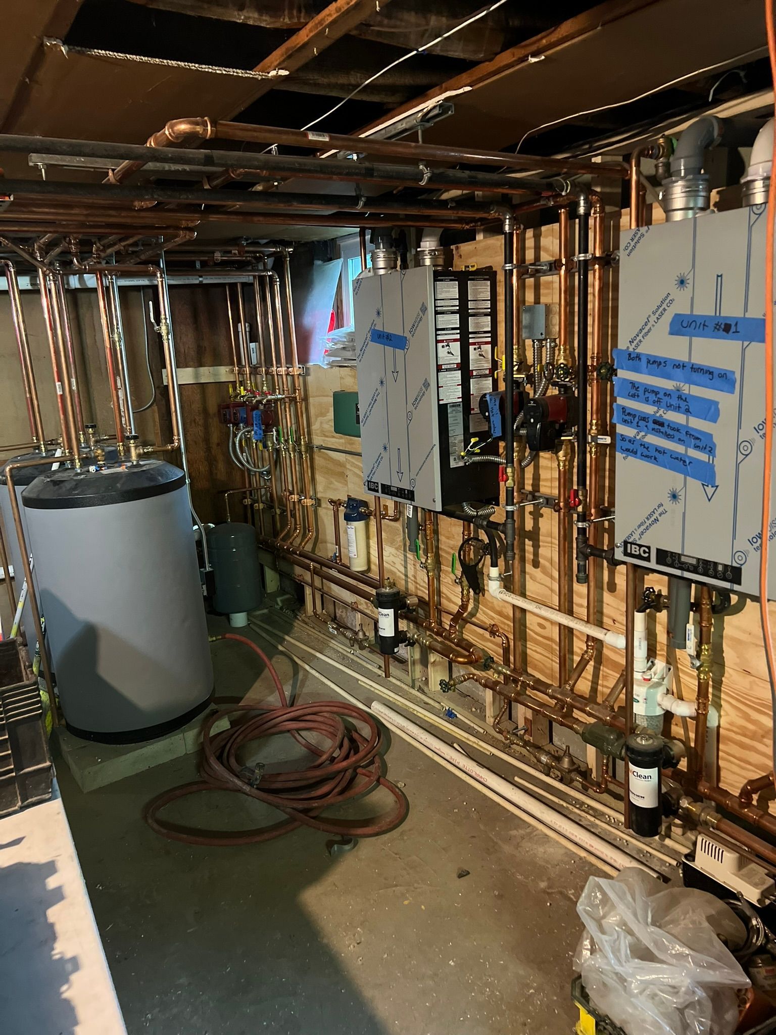 a room with a lot of pipes and a water heater