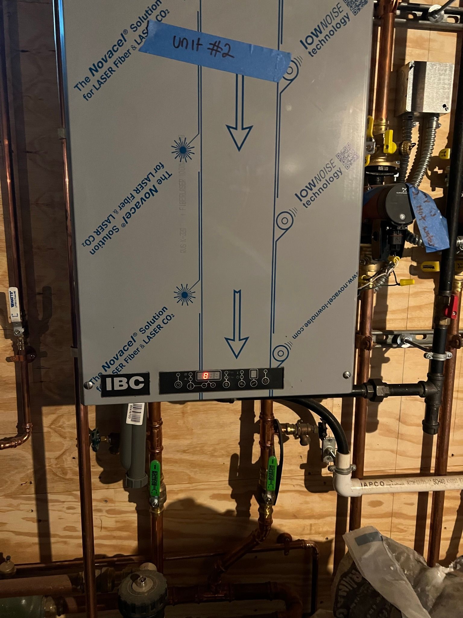 a stainless steel water heater is being installed in a basement