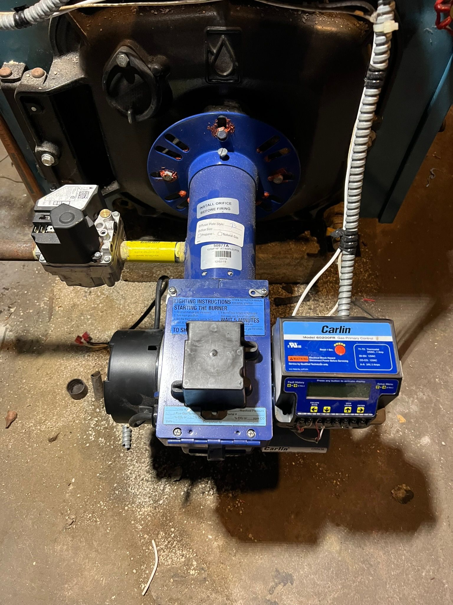 a blue burner is sitting on top of a blue boiler