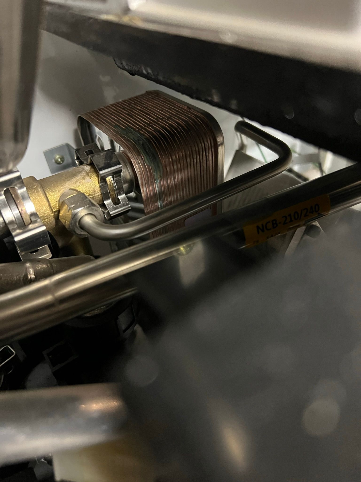 a close up of a metal pipe with a warning sign on it