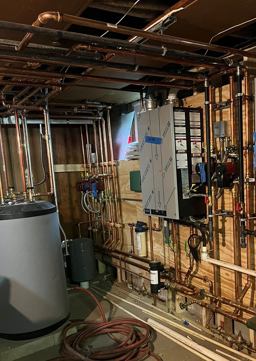 a room with a lot of pipes and a water heater