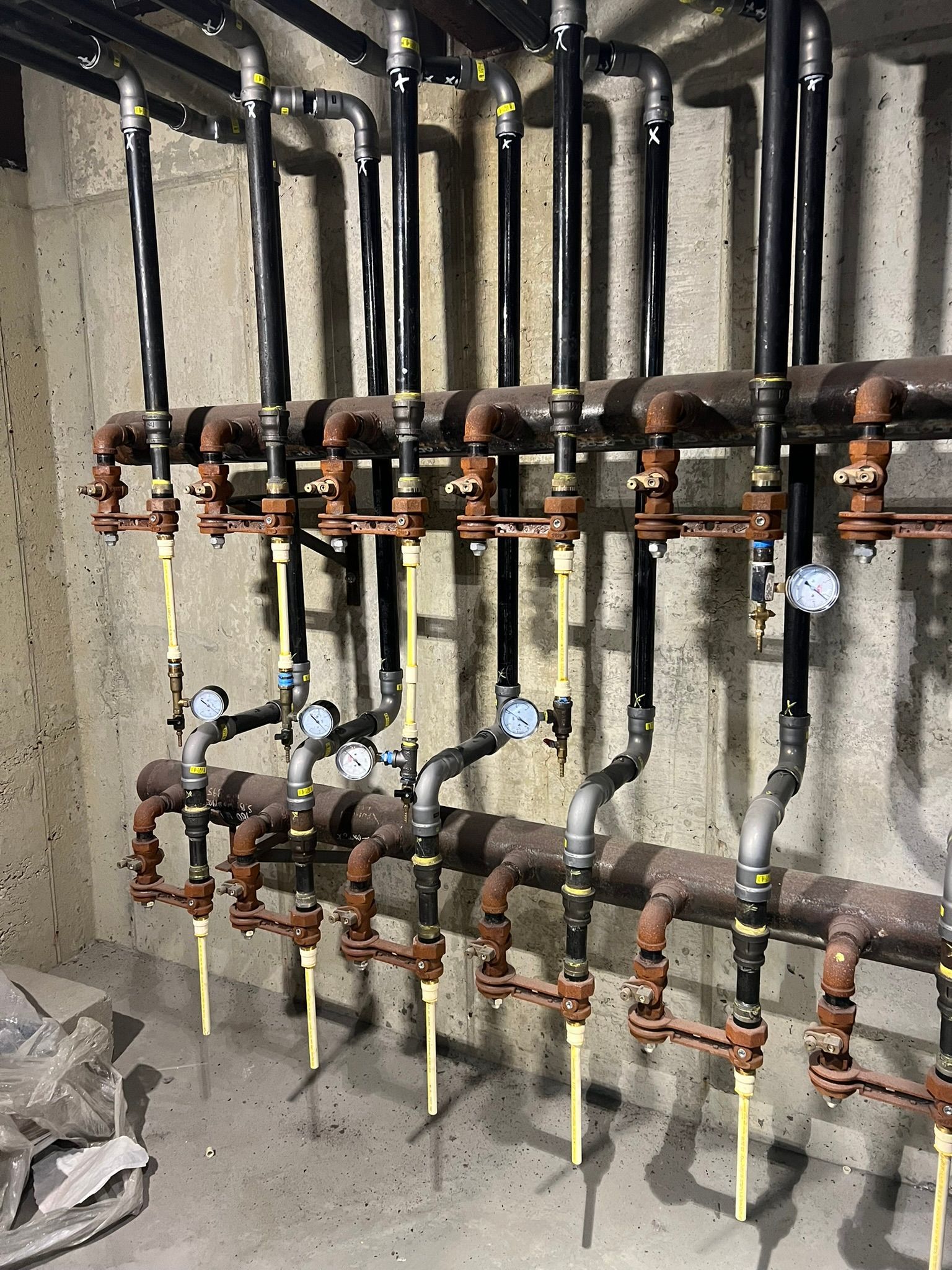 a room filled with lots of pipes and gauges