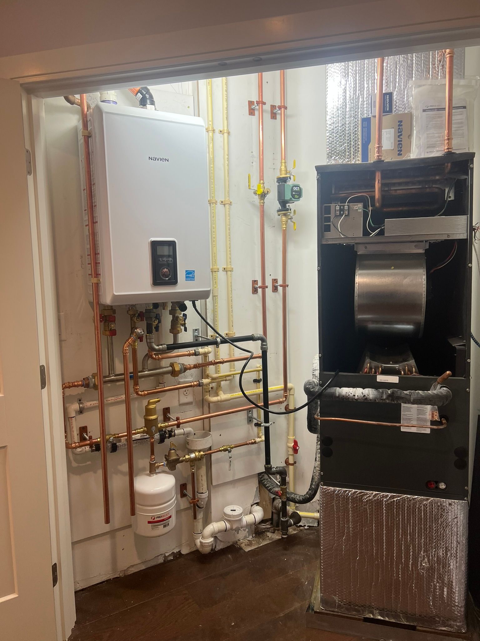 a room with a boiler and pipes in it