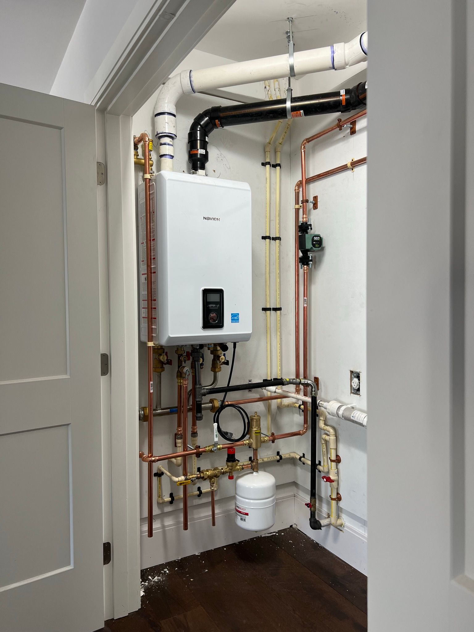 a room with a boiler and pipes in it