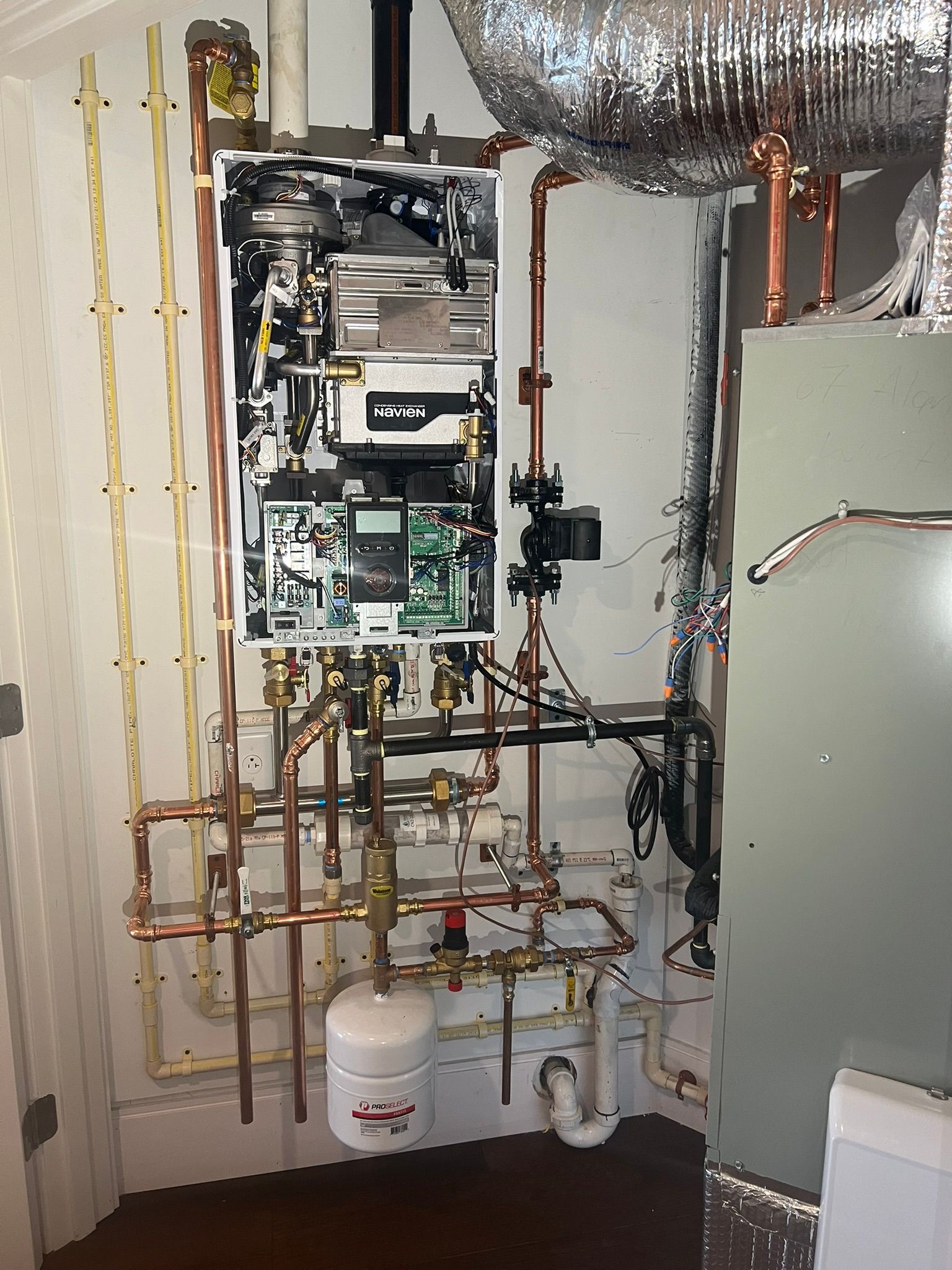 a room with a boiler and a lot of pipes