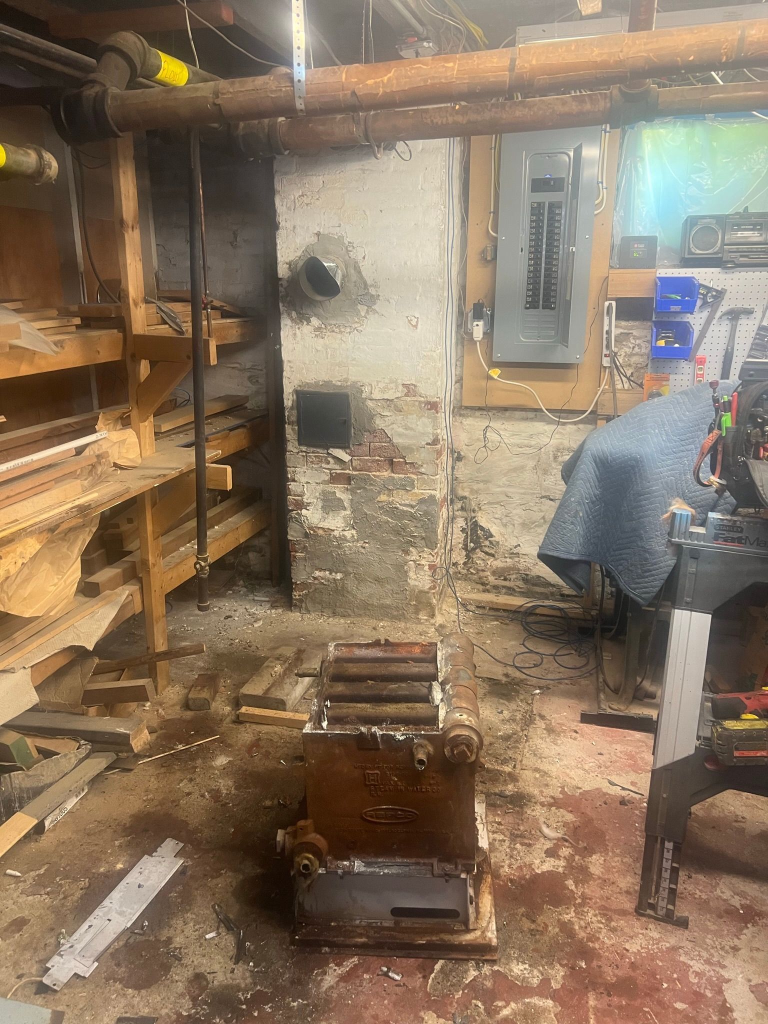 a dirty basement with a lot of tools on the floor