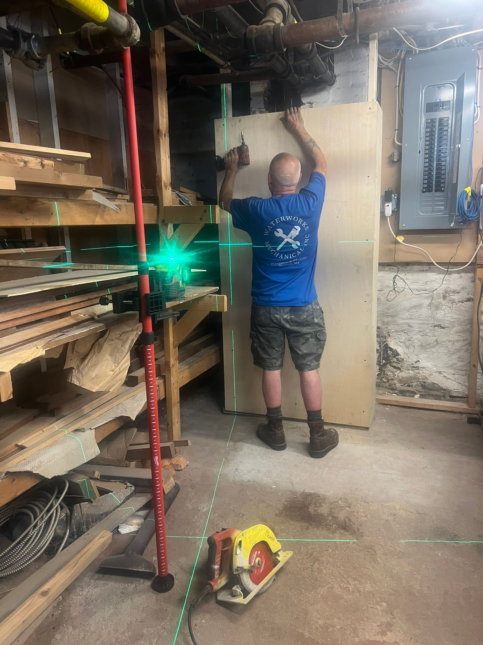 a man is measuring a piece of wood in a basement