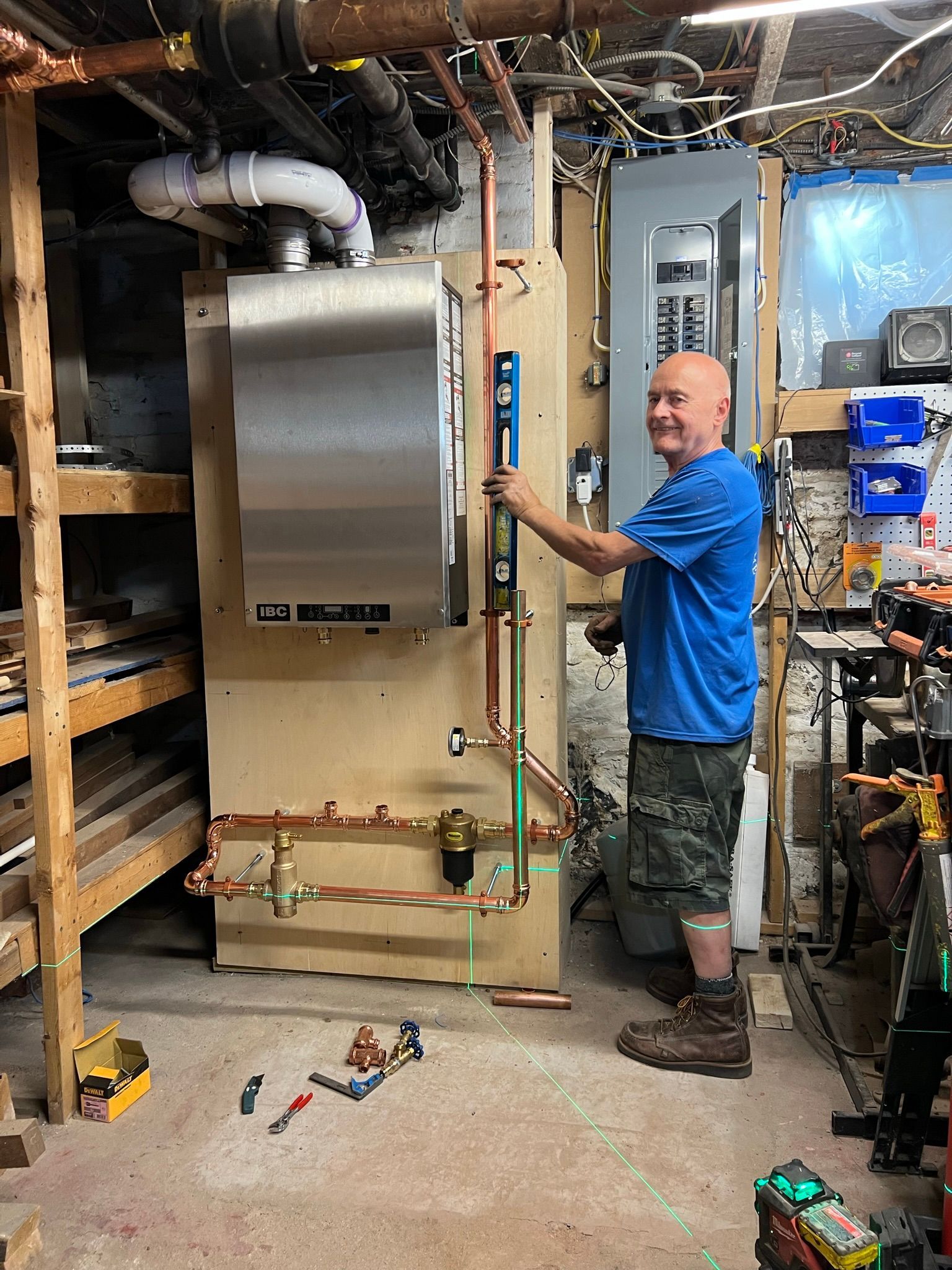 a man is working on a boiler in a basement