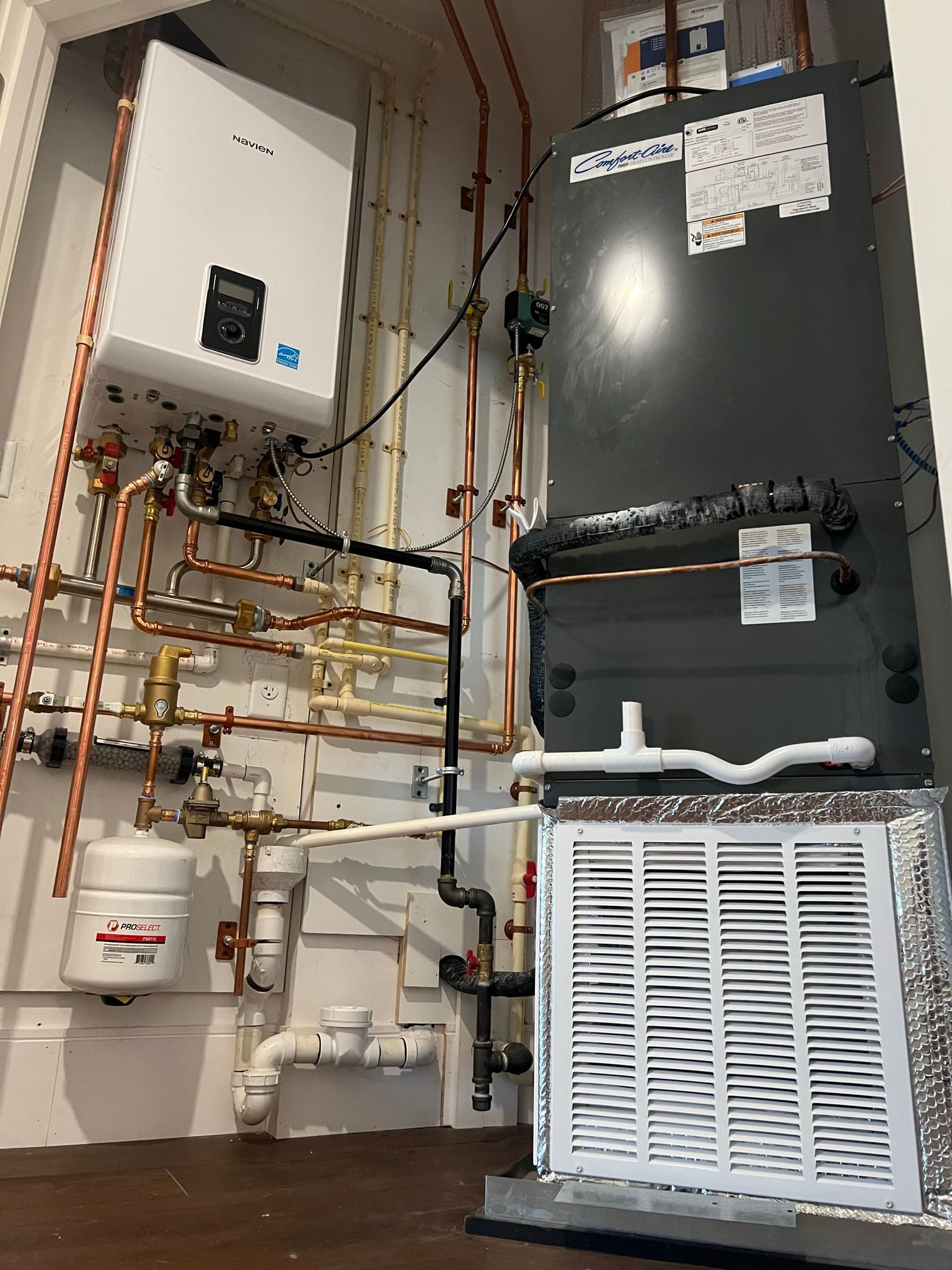 a room with a lot of pipes and a heater