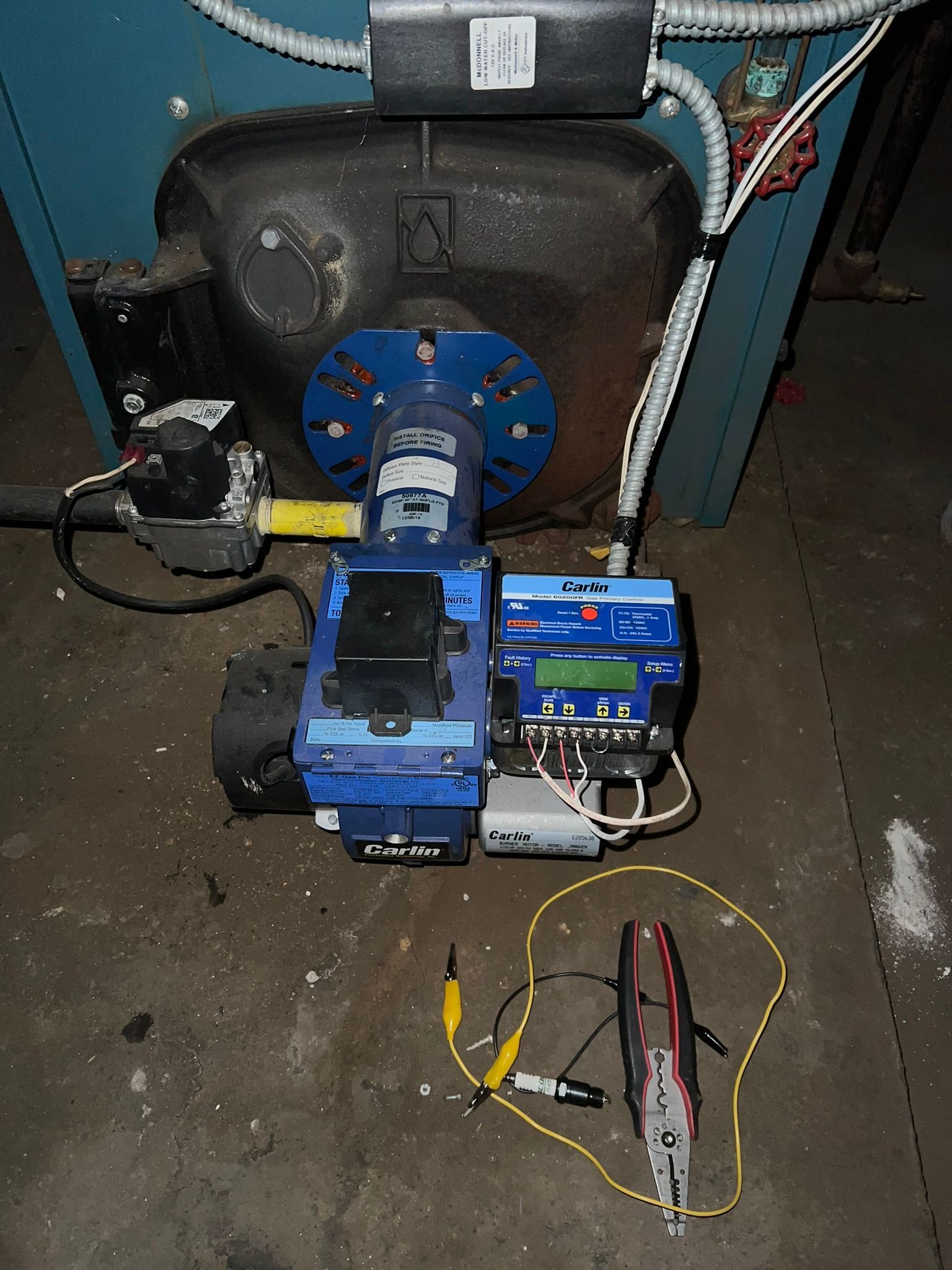 a boiler with a bunch of wires attached to it