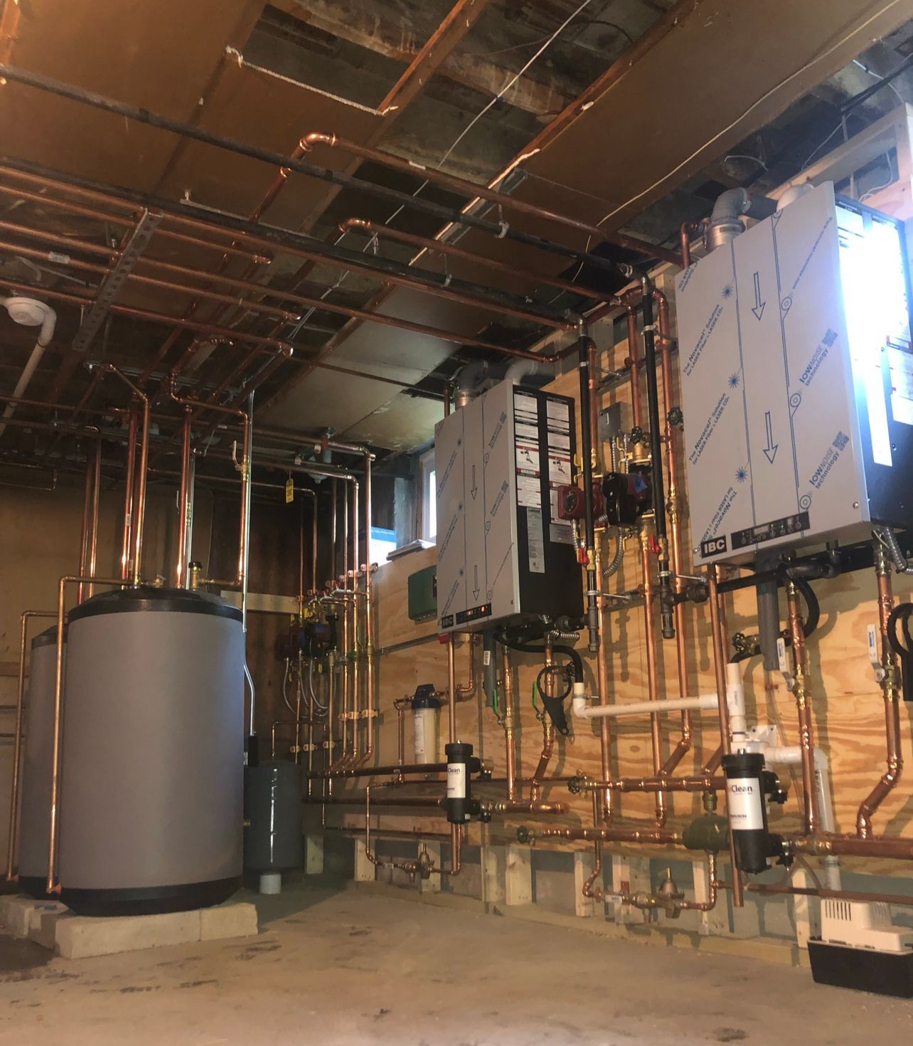 a room with a lot of pipes and a sign that says 'copper' on it