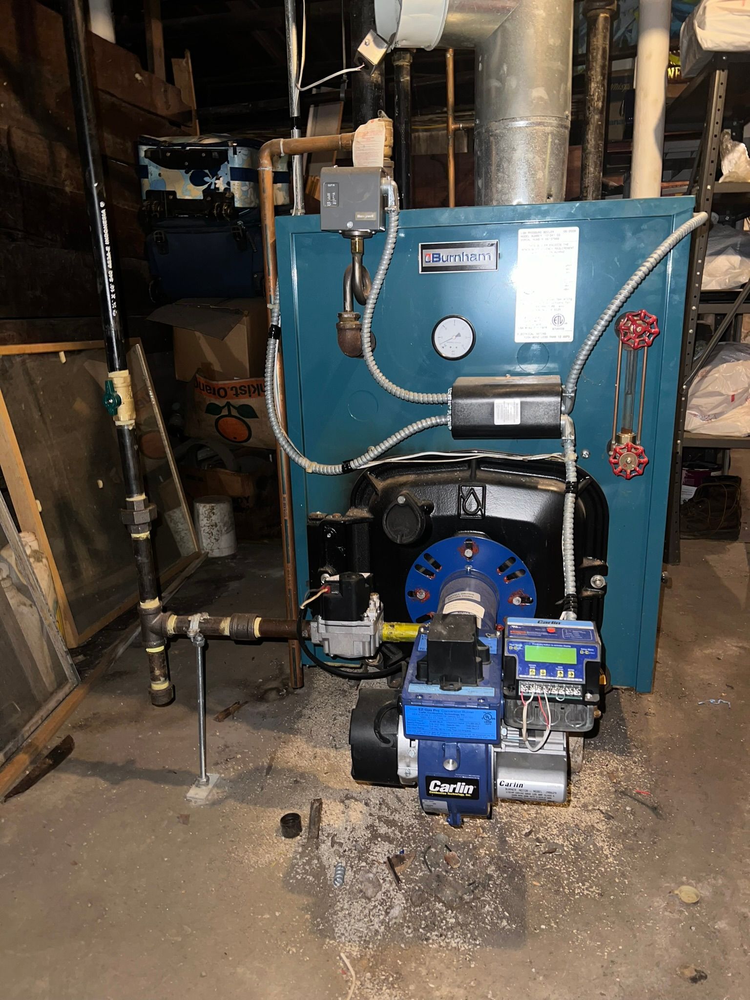 a blue boiler is sitting in a dark room