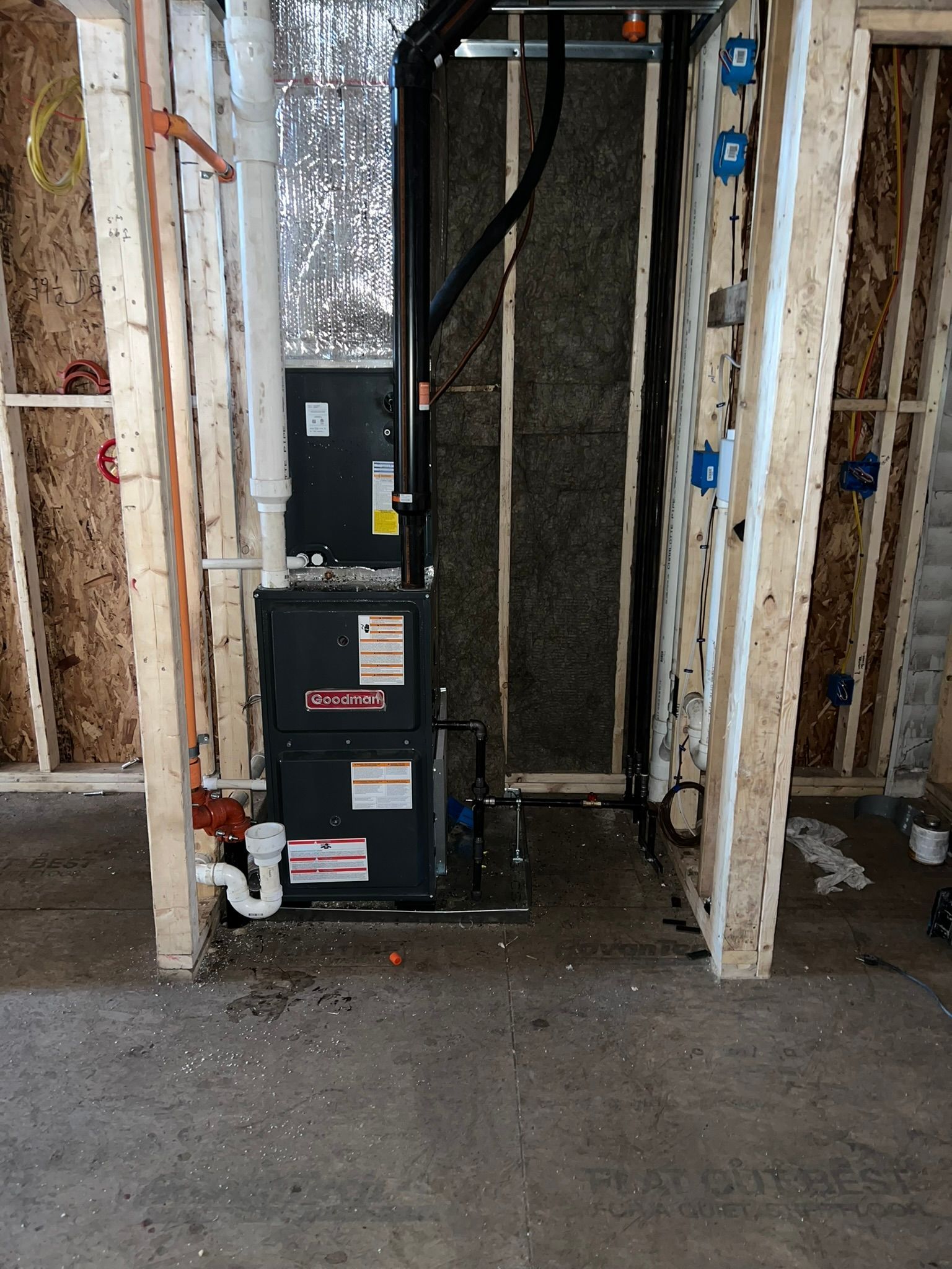 a basement with a furnace and pipes in it