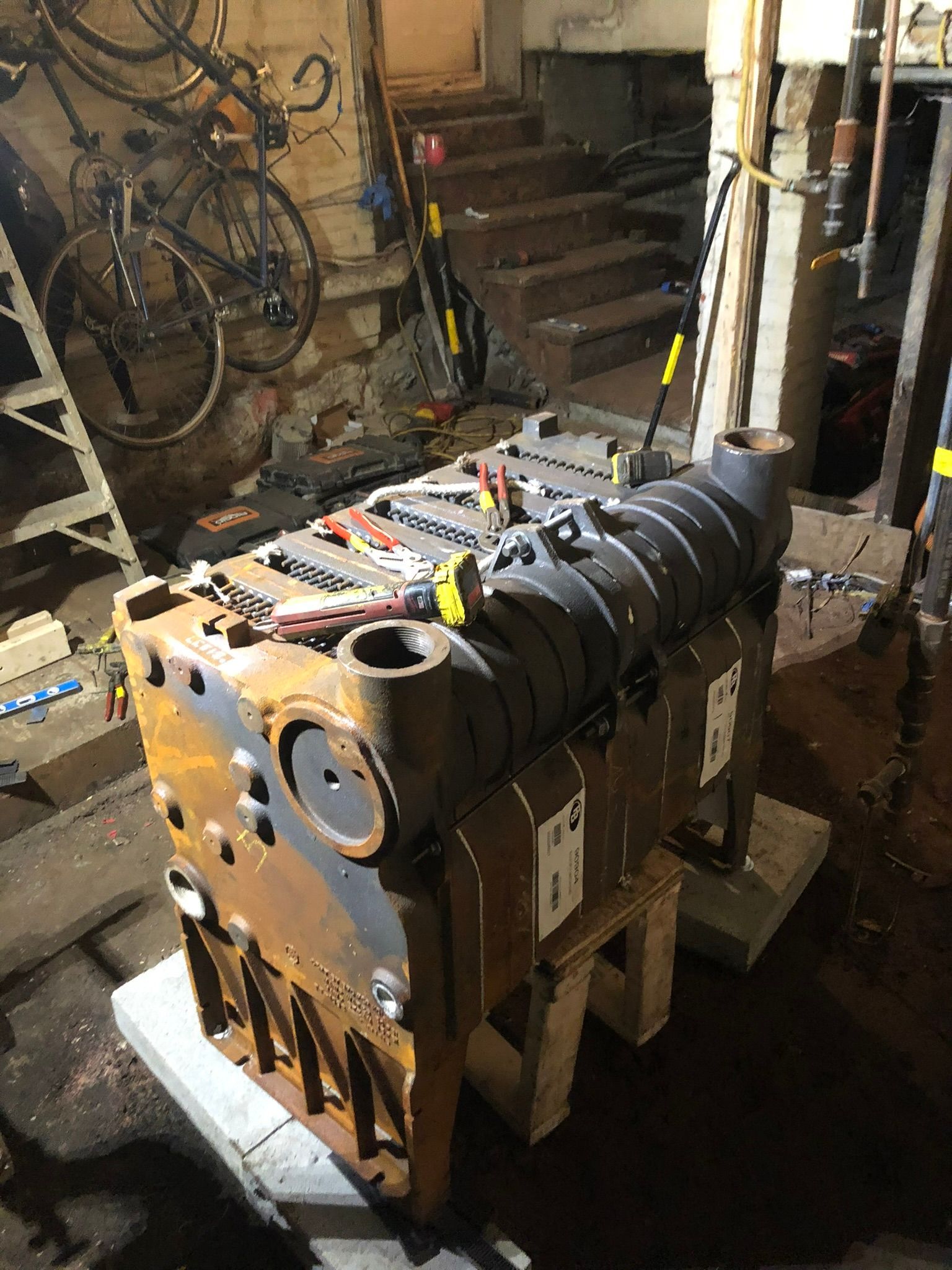 a large piece of metal is sitting on top of a wooden table in a garage