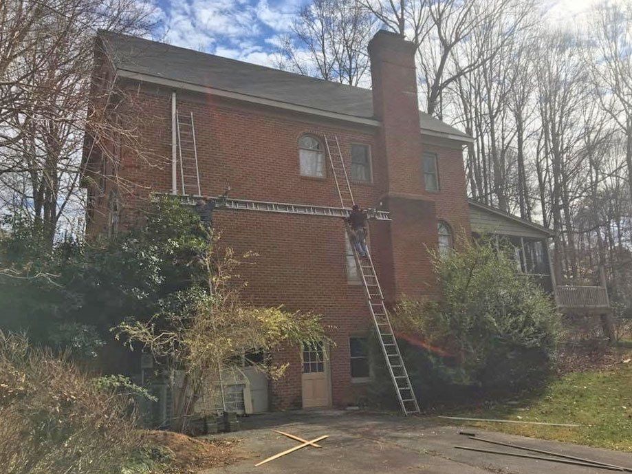 Gutter installation in a big house with chimney