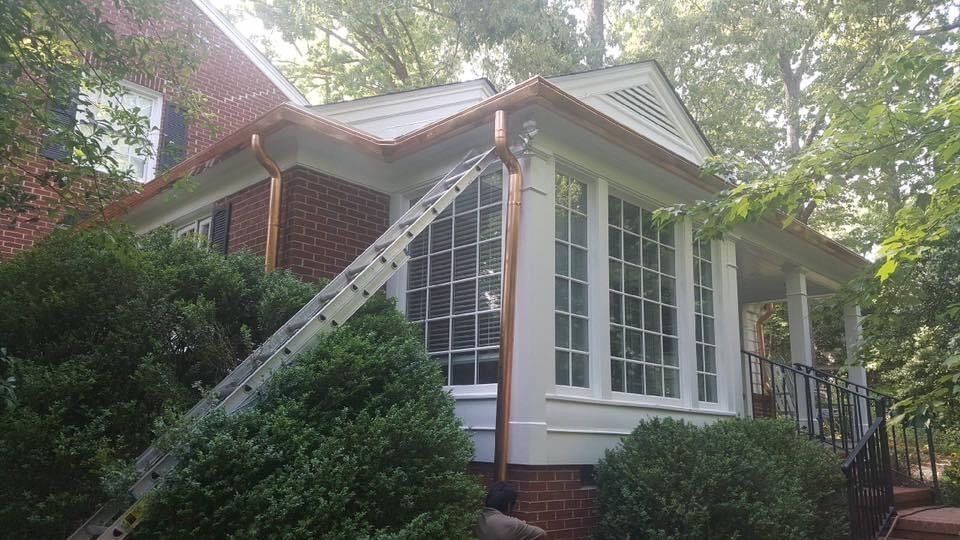 Gutter repair and installation in a house with big windows