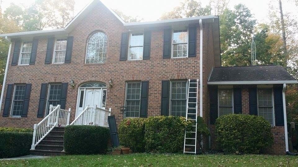 Gutter installation in a big brick house