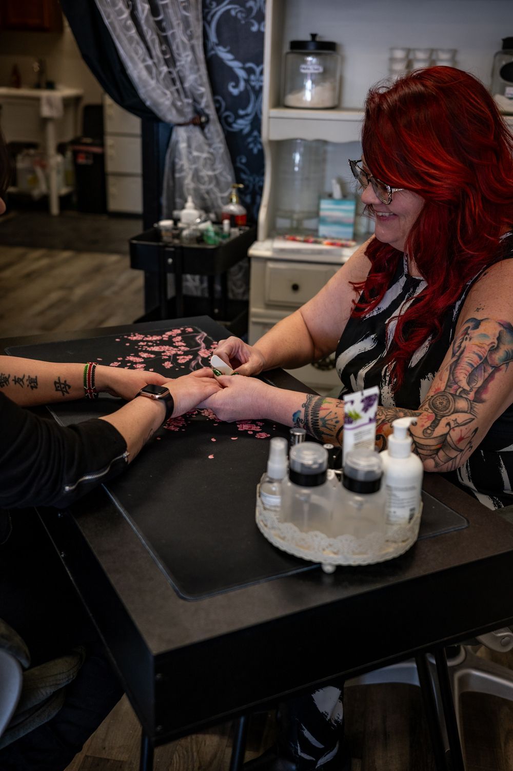 A woman is getting her nails done at a salon.