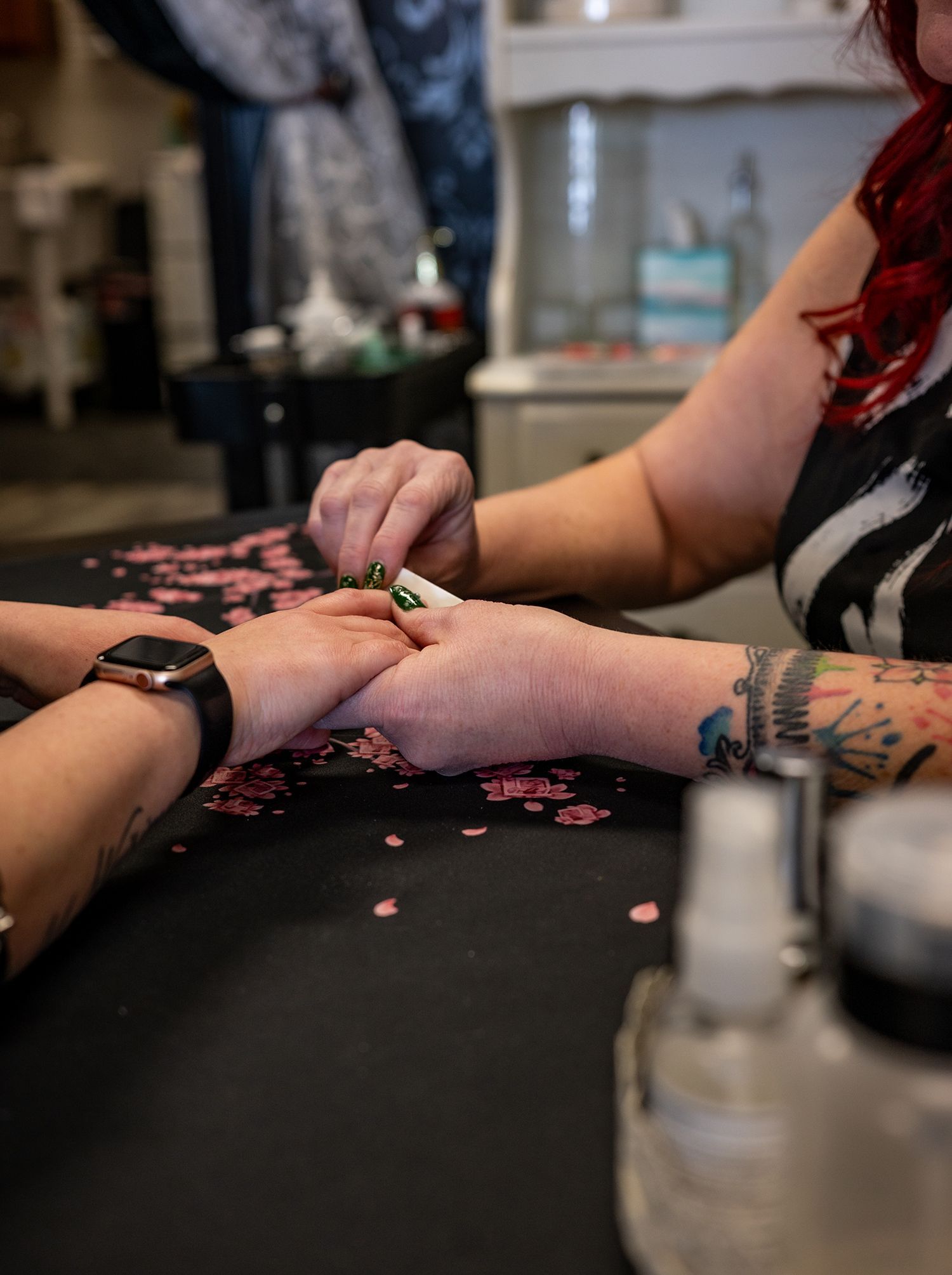 A woman is getting her nails done at a salon.