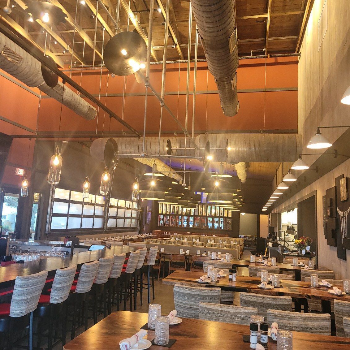 A restaurant with a lot of tables and chairs