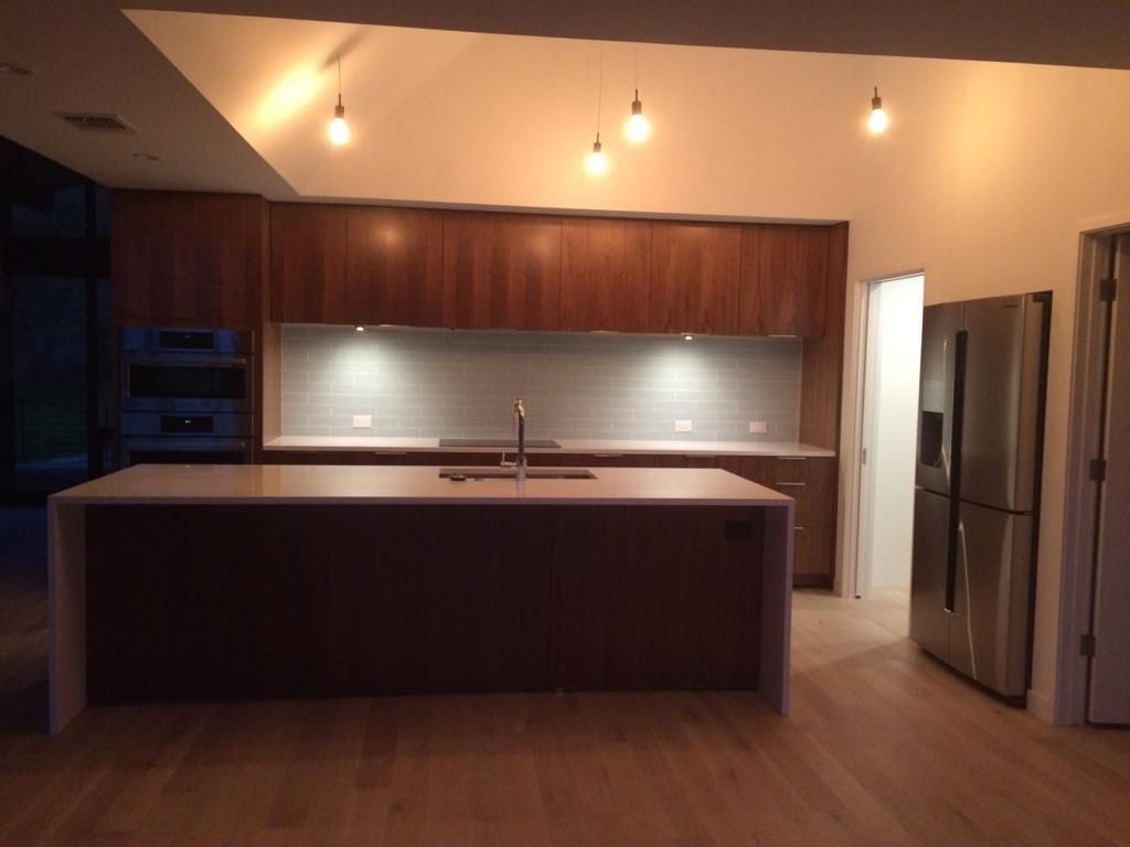 A kitchen with stainless steel appliances and wooden cabinets