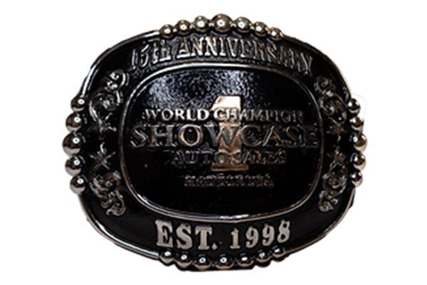 A belt buckle that says ' world champion showcase ' on it