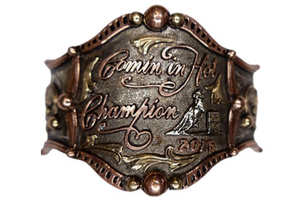 A belt buckle that says ' coming in hot champion ' on it