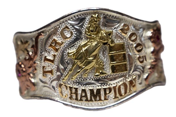 A silver and gold belt buckle with the word champion on it