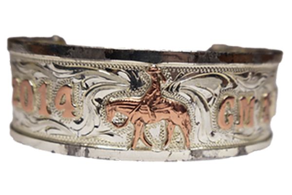 A silver bracelet with a man riding a horse on it
