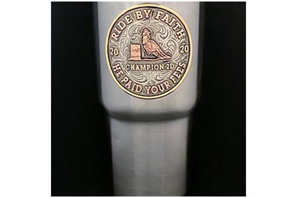 A stainless steel tumbler with a cowboy boot buckle on it.
