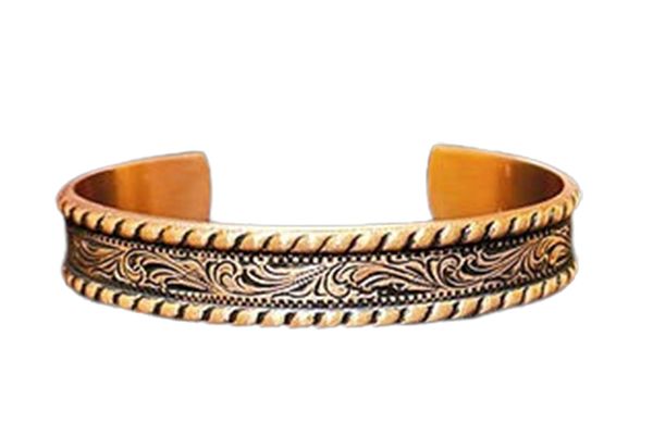 A close up of a copper bracelet on a white background.