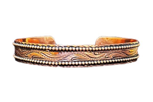 A close up of a copper bracelet on a white background.