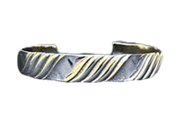 A close up of a silver and gold bracelet on a white background.