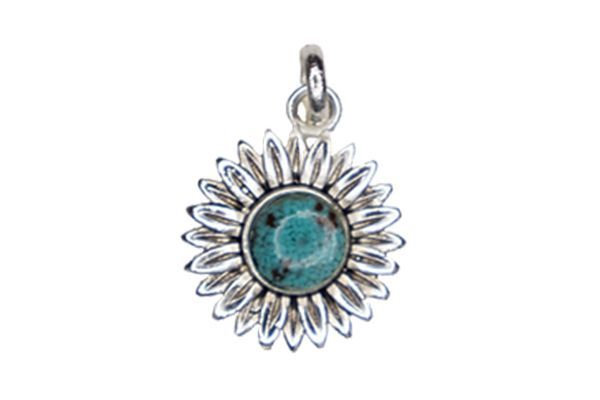 A silver pendant with a turquoise stone in the center