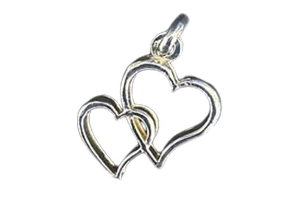 A silver pendant with two intertwined hearts on a white background