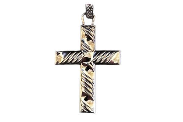 A cross with a zebra print on it is on a white background.