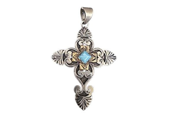 A silver cross pendant with a blue stone in the middle on a white background.