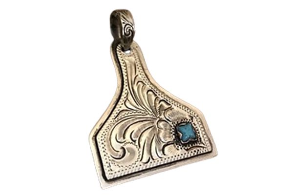 A silver pendant with a turquoise stone on it