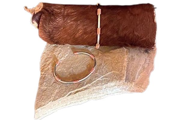 A piece of brown fur with a bracelet on it