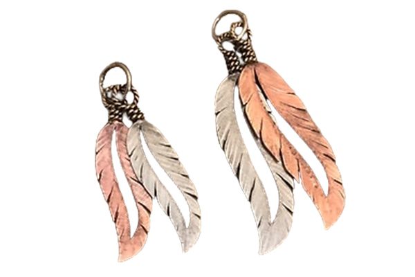 A pair of silver and copper feather earrings on a white background