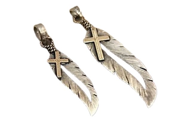 Two silver feathers with crosses on them on a white background
