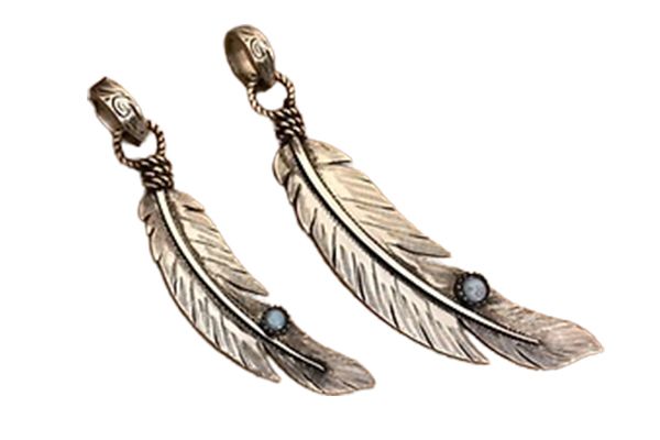 A pair of silver feather pendants with a black stone in the middle