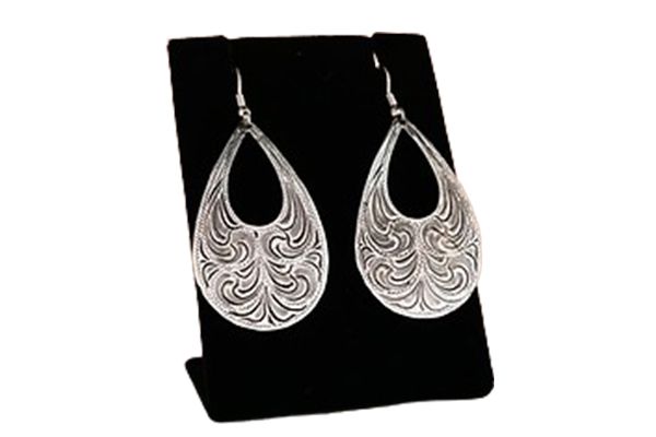 A pair of silver earrings are sitting on a black display stand.