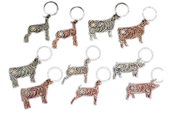 A group of keychains with cows on them on a white background.