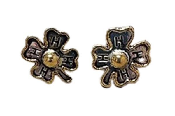 A pair of earrings in the shape of a flower on a white background.