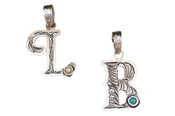Two pendants in the shape of the letter b on a white background.
