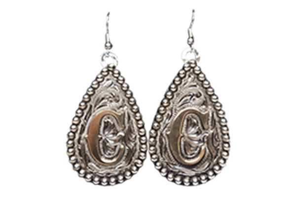 A pair of earrings with the letter c on them