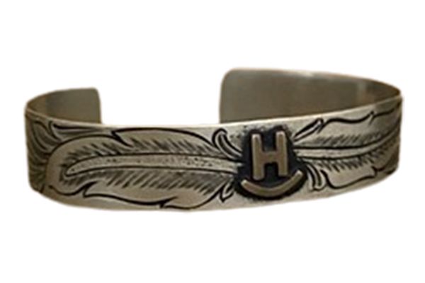 A silver bracelet with the letter h on it